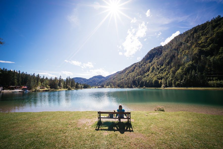 Kitzbüheler Alpen Hero Wandern Monika Günther auf einer Bank und genießt den Ausblick über den Pillersee c Daniel Gollner